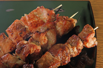 skewer on a black plate