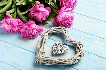 Bouquet of pink peony flowers on wooden table