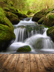 Beautiful waterfall with wooden planks