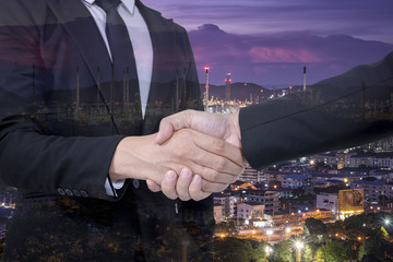 Double exposure of businessman with Oil Refinery and Cityscape background, Business Trading concept