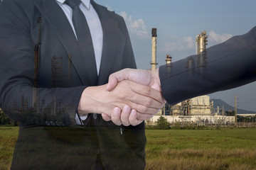 Double exposure of businessman with Oil Refinery and Cityscape background, Business Trading concept