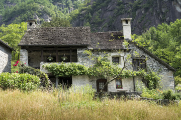 Fototapeta na wymiar Ancient stone house in the Swiss Alps