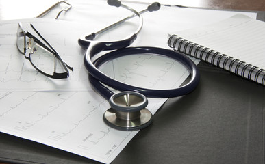 Close up of stethoscope and a waveform from an EKG test