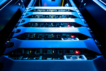 Computer Server mount on rack in data center room with red lighting alarm..