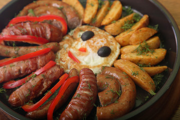 sausage and peppers with potatoes in a pan