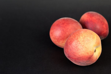 Close up shot of fresh peaches on a black background