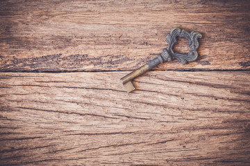 Old key on a wooden background