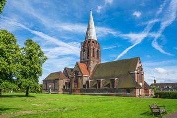 Old brick church in the Hampstead Garden Suburb square, London, UK