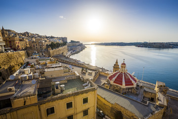 Sunrise at the Grand Harbour of Malta with the ancient walls of Valletta