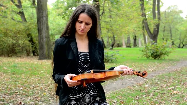young attractive displeased woman hold violin and shake with head 