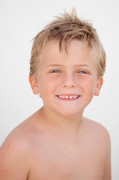 Funny blond boy looking at camera