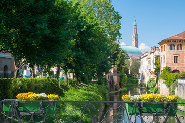 Flowered balcony of Monte Furo in Vicenza, Italy, with a view of retrone river and the clock tower in the distance