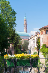 Obraz premium Flowered balcony of Monte Furo in Vicenza, Italy, with a view of retrone river and the clock tower in the distance