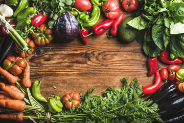 Fresh raw vegetable ingredients for healthy cooking or salad making over rustic wood background,...
