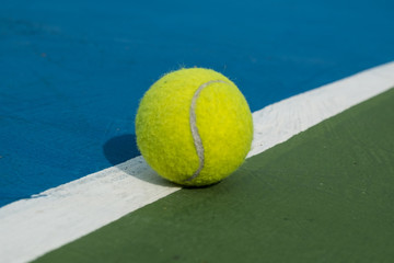 tennis ball on a court line