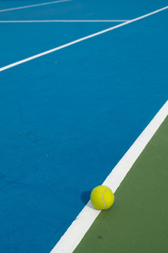 tennis ball on the line in tennis court