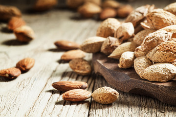 Shelled and unshelled almonds, selective focus