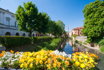 Fototapeta premium Flowered balcony of Monte Furo in Vicenza, Italy, with a view of retrone river and the clock tower in the distance