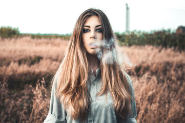 Young girl smoking outdoors - 115654356
