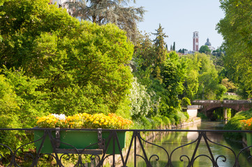 Flowered balcony of Monte Furo in Vicenza, Italy, with a view of retrone river and the basilica of Mount Berico in the distance