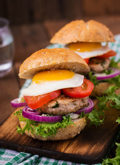 Hamburger (Sandwich) with chicken burger, lettuce, tomato, fried egg and tartar sauce