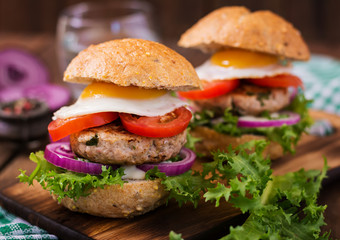 Hamburger (Sandwich) with chicken burger, lettuce, tomato, fried egg and tartar sauce