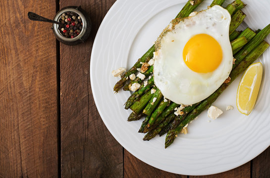 Warm salad of roasted asparagus, feta cheese and eggs. Top view