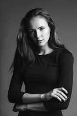 Obraz premium monochrome fashion moody portrait of young woman on gray background