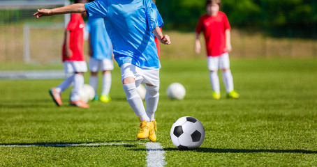 Children playing football soccer game on sports field