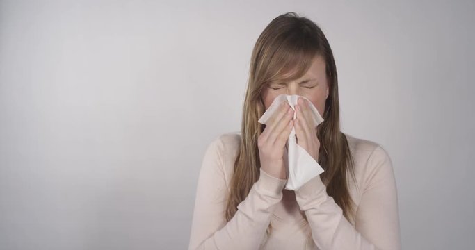 Woman blows her nose