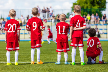 Football soccer match for children. Youth football soccer team on sport stadium. Sports school...