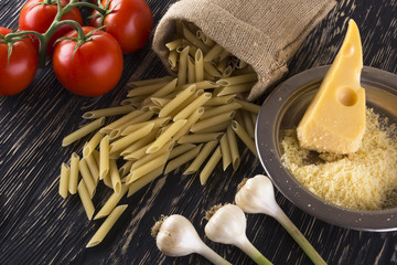 Pasta, tomatoes, garlic and grated cheese.