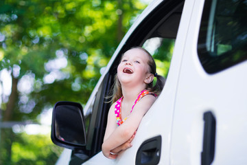 Fototapeta na wymiar Little girl sitting in white car