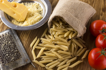 Pasta, tomatoes and grated cheese.