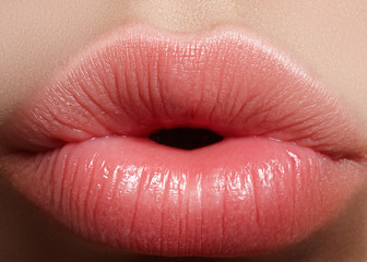 Sweet kiss. Perfect natural lip makeup. Close up macro photo with beautiful female mouth. Plump...