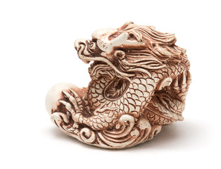 Netsuke of east dragon, which guarding the egg. Isolated