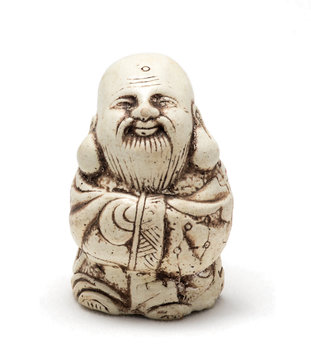 Netsuke of a satisfied man in a dressing gown. Isolated