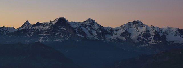 Famous mountains Eiger Monch and Jungfrau at sunrise