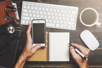 Overhead view of business workspace with the hand of businessman