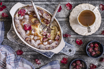Clafoutis with cherries and powdered sugar for breakfast  