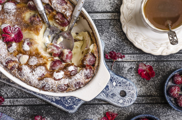 Clafoutis with cherries and powdered sugar for breakfast  