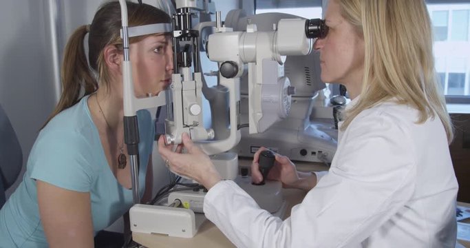 Optometrist performing visual field test