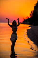 Woman standing on the beach doing yoga