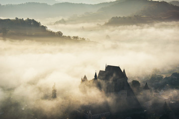 Misty morning over Biertan village, Transylvania, Romania - obrazy, fototapety, plakaty
