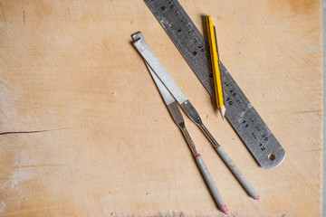Overhead of Rasps, Pencil, and Metal Rule on Wooden Surface