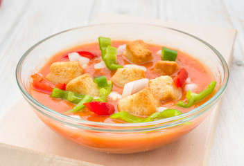 Andalusian gazpacho soup with vegetables and croutons in round b
