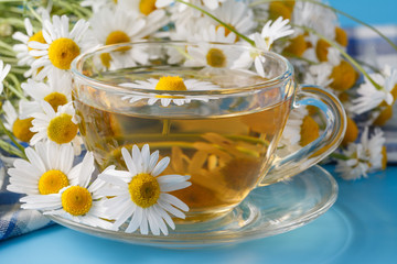 Detail of cup of herbal tea and chamomile.