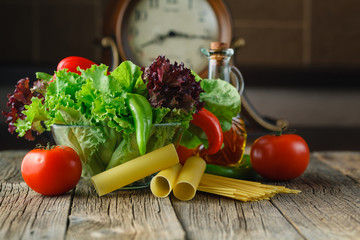 Fresh ingredients for cooking: pasta, tomato and spices