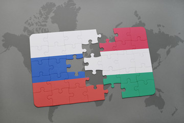 puzzle with the national flag of russia and hungary on a world map background.