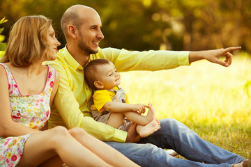 Happy family having fun. Baby boy with his mother and father